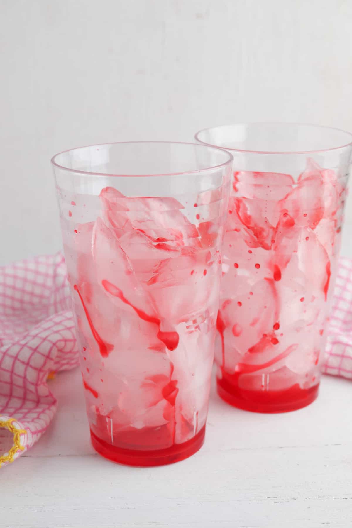 Red syrup over ice in glass.