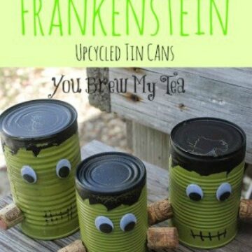 Tin cans with googly eyes decorated for Halloween.
