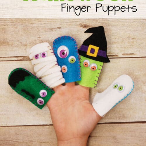 Hand with Halloween finger puppets.