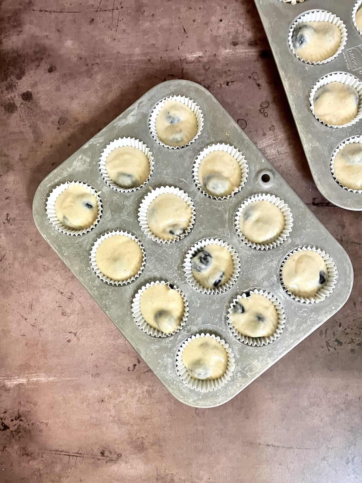 Batter in lined muffin tin.
