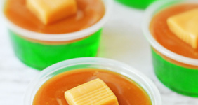 Green Jello with a layer of caramel and caramel candy on top.