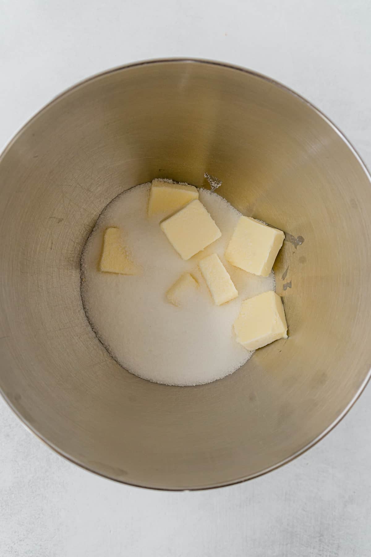 Sugar and butter in a stainless bowl.