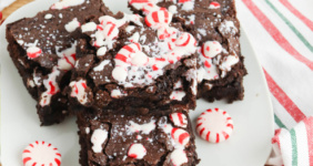 Brownies with peppermint on white plate for Pinterest.