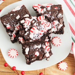 Brownies with peppermint on white plate.