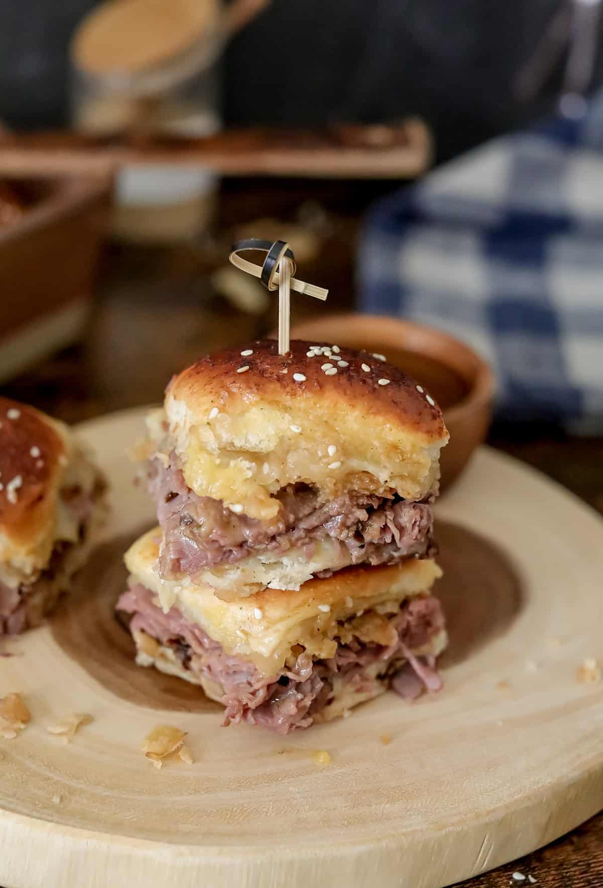 Oven baked French dip sliders with cheese and au jus.