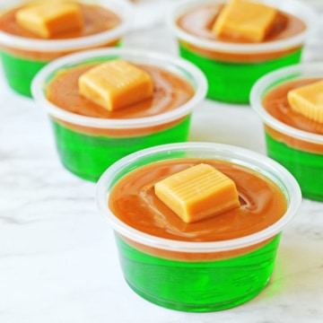 Green jello with caramel layer and caramel candy on top.