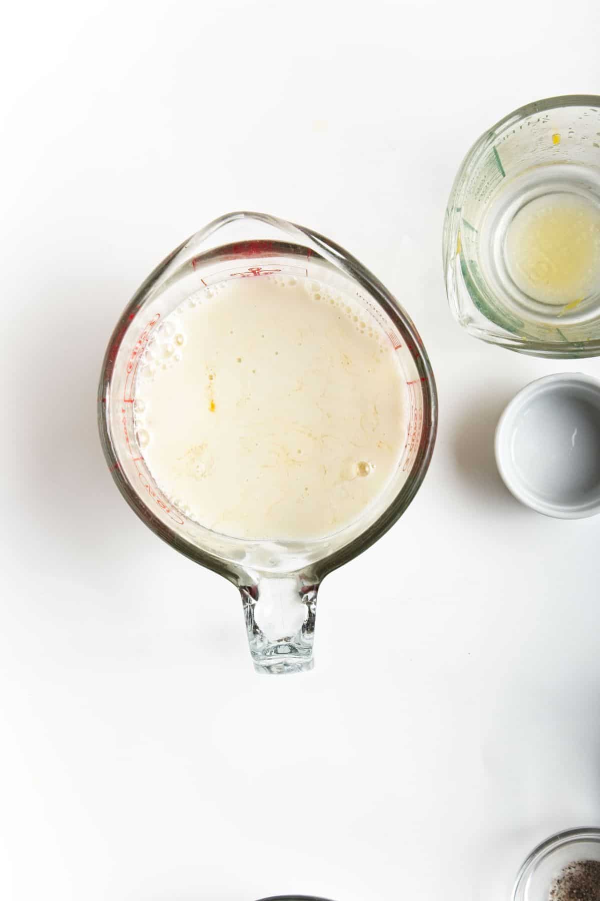 Milk in glass measuring cup.