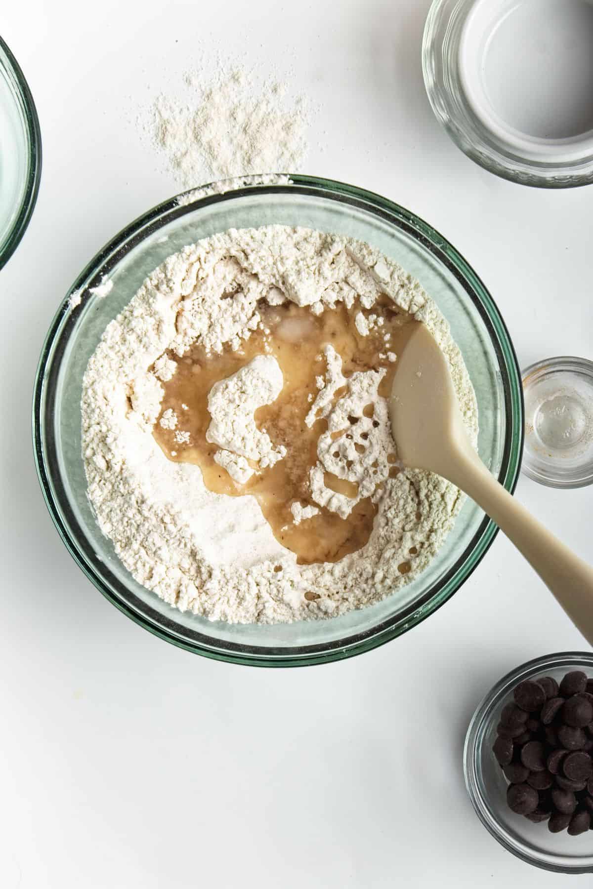 Coconut oil in flour mixture in bowl on white counter.