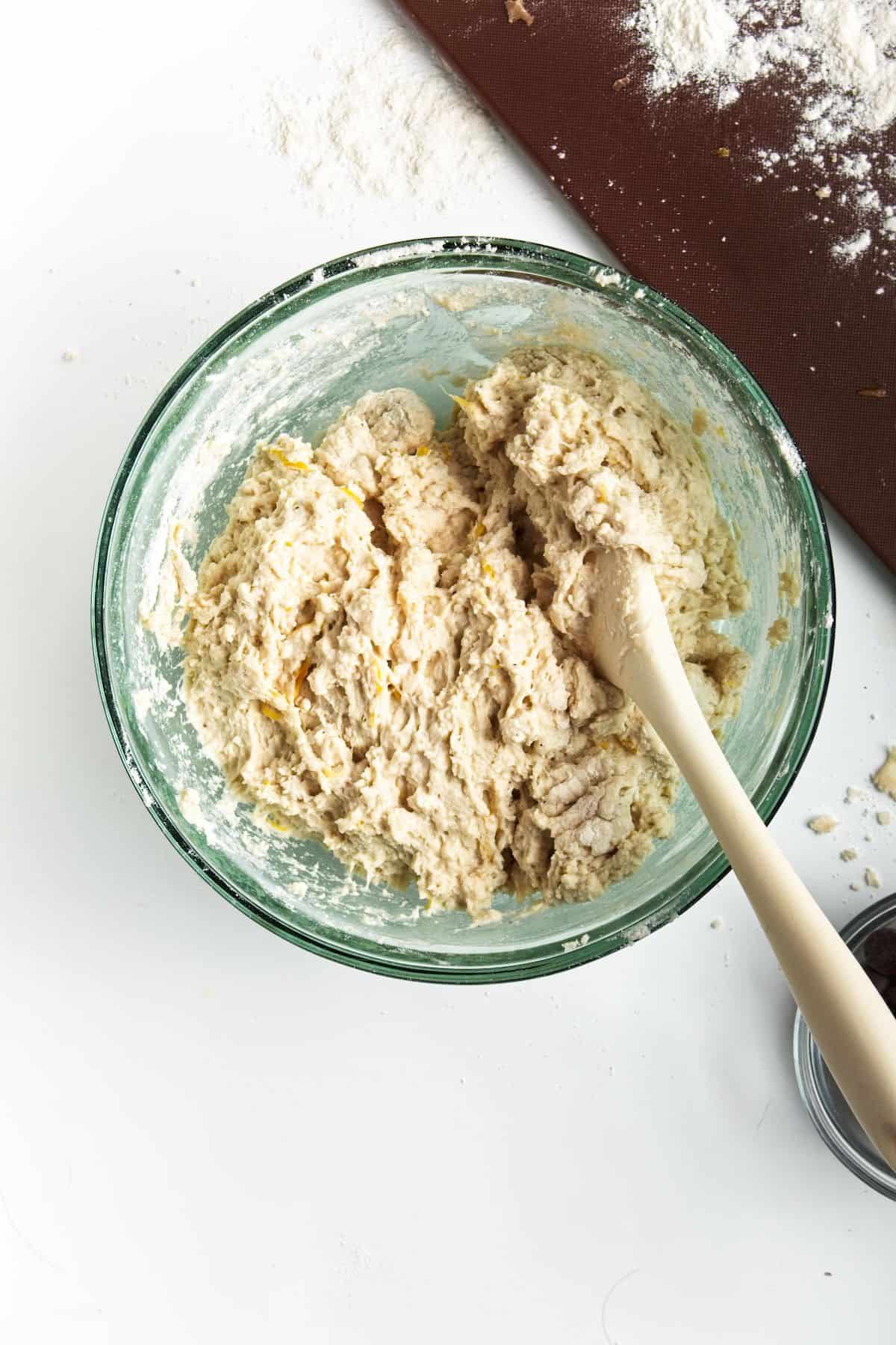 Wet dough in glass bowl.