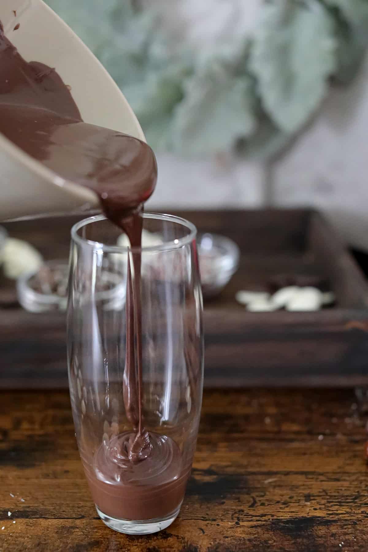 Pouring chocolate into a glass.