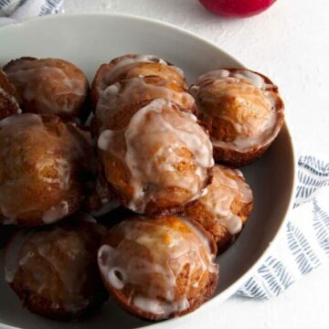 Apple fritters in a white bowl.
