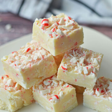 White chocolate peppermint fudge on a white plate.