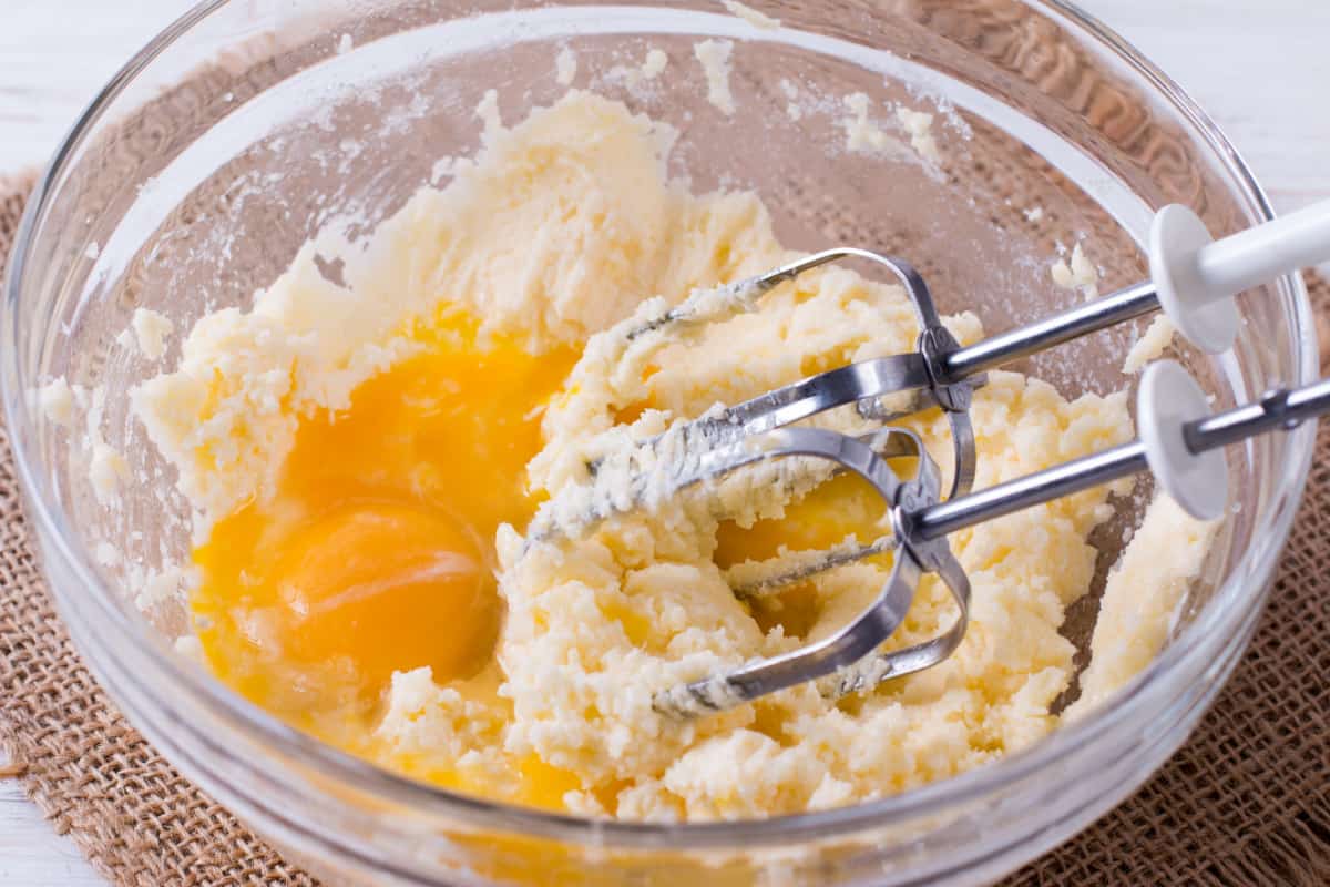 Butter, sugar, and eggs in glass bowl.