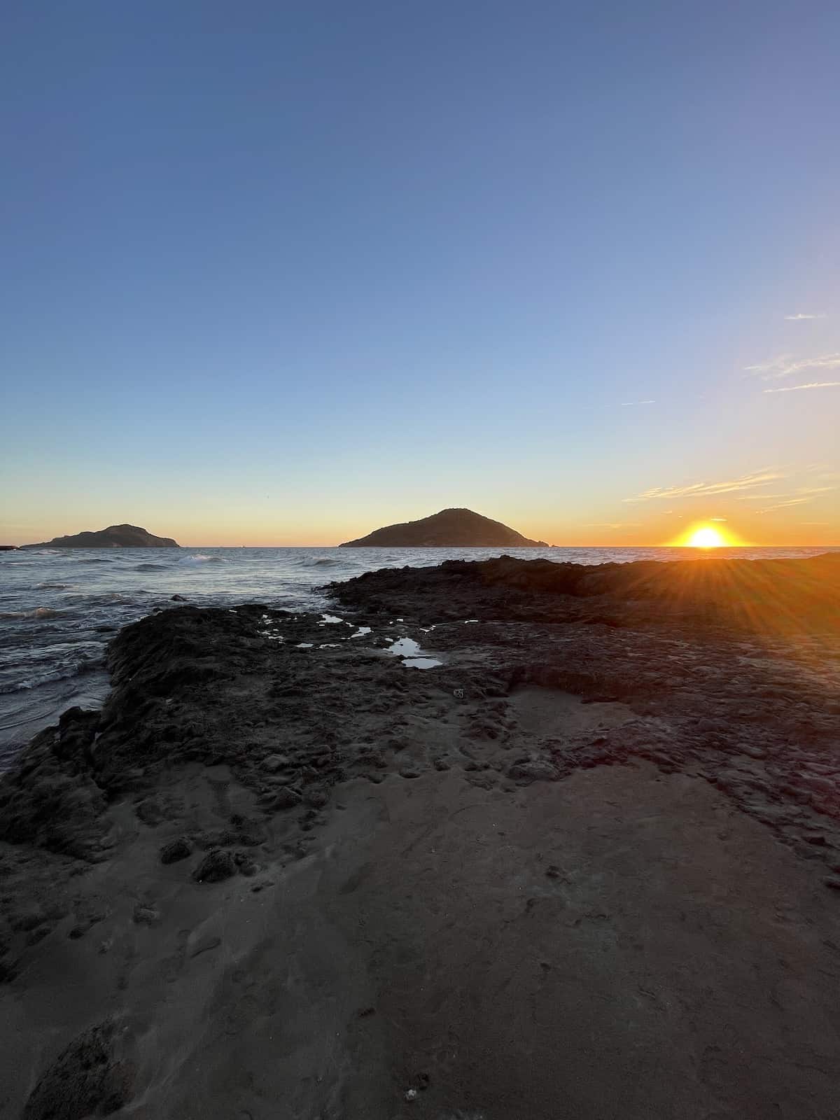 Sunset against island.