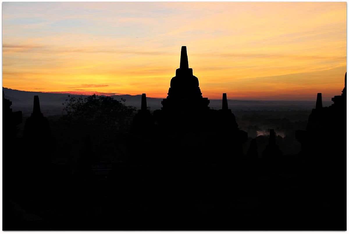 Sunrise behind a temple.