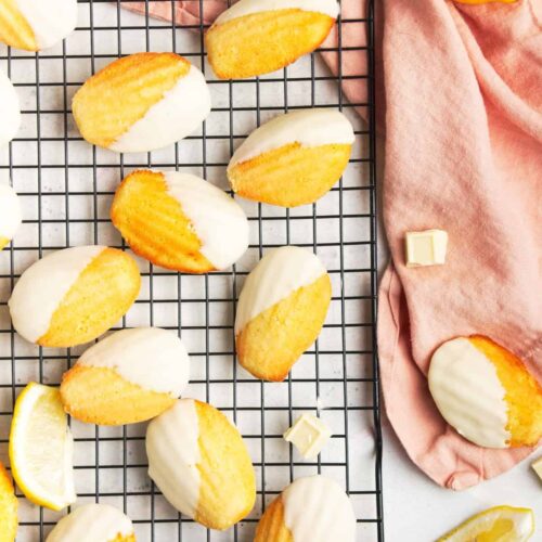 Madeleine cookies on a wire rack with a pink napkin.