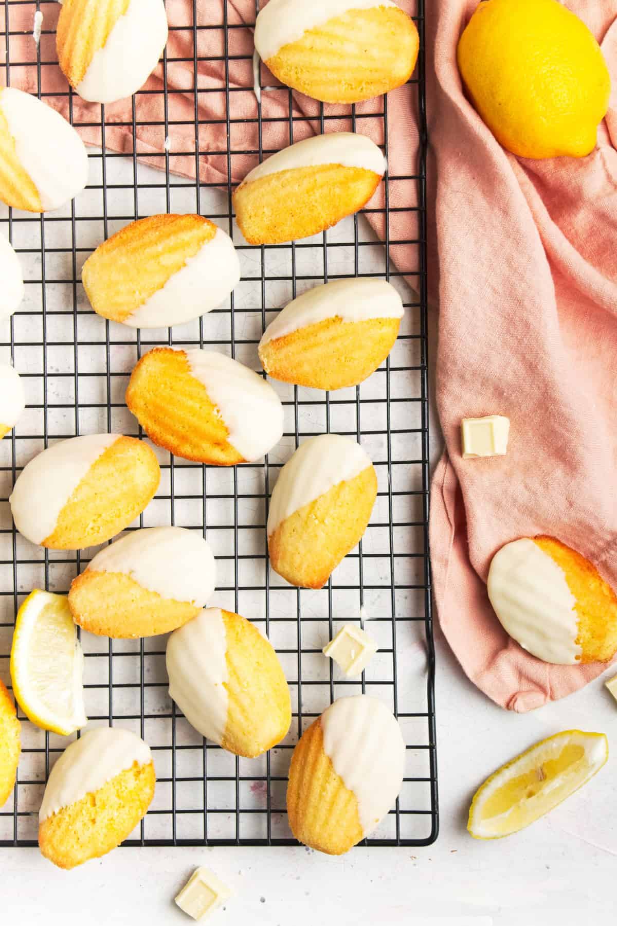 Madeleine cookies on a wire rack with a pink napkin.