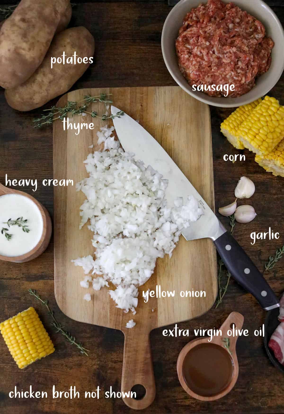 Corn chowder ingredients on and around a wood cutting board.