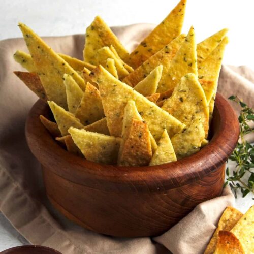 Homemade vegan crackers on a clay bowl.