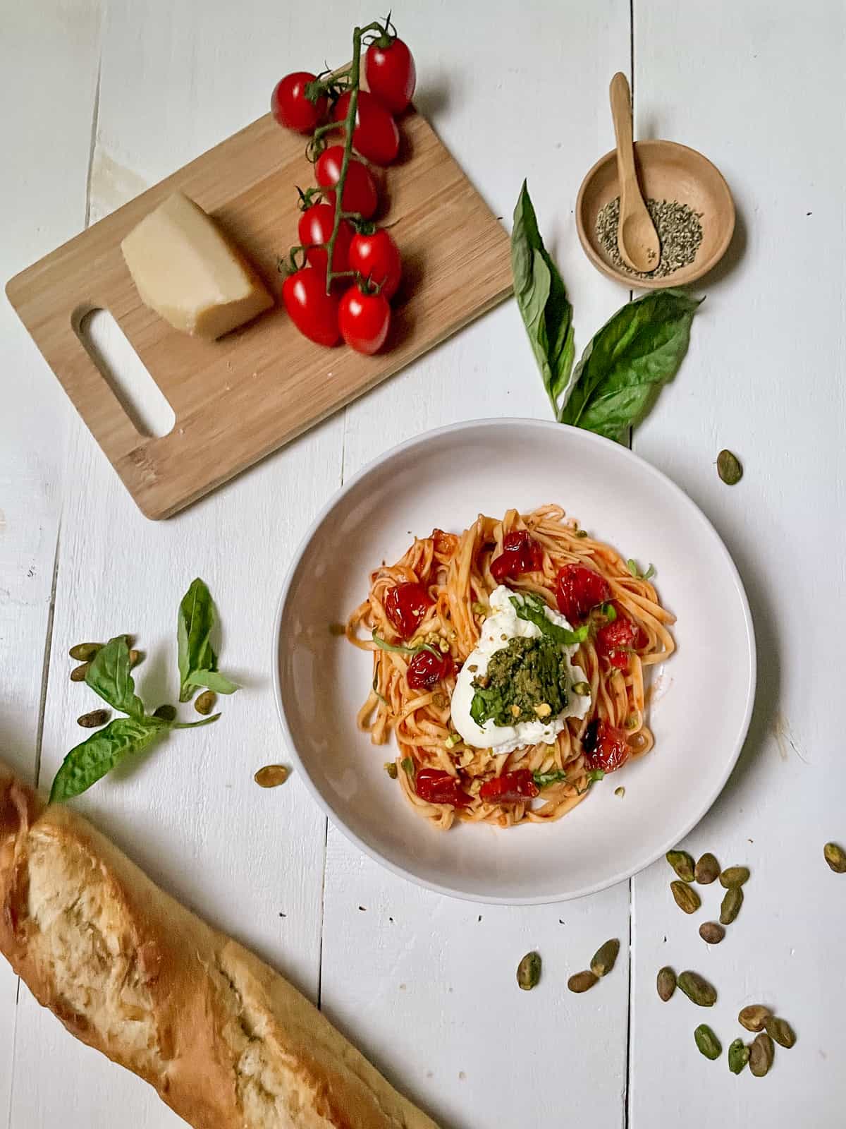 Fettuccine with grape tomatoes, ricotta, and pesto with load of bread.