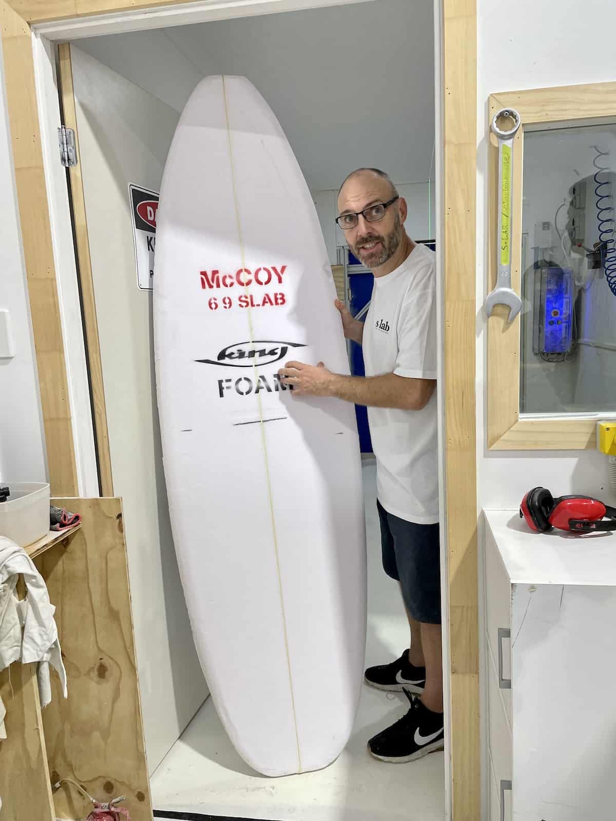 Man with a foam surfboard.