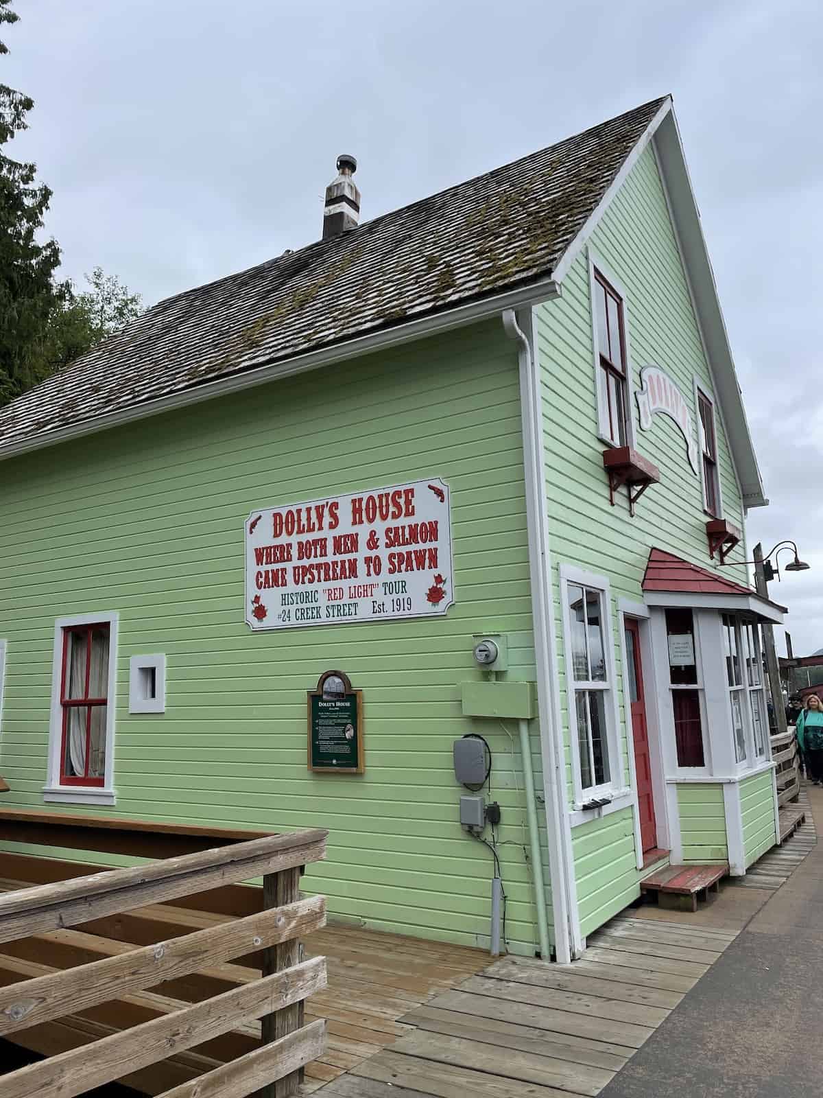 Green house with sign for Dolly's House on the red light tour.