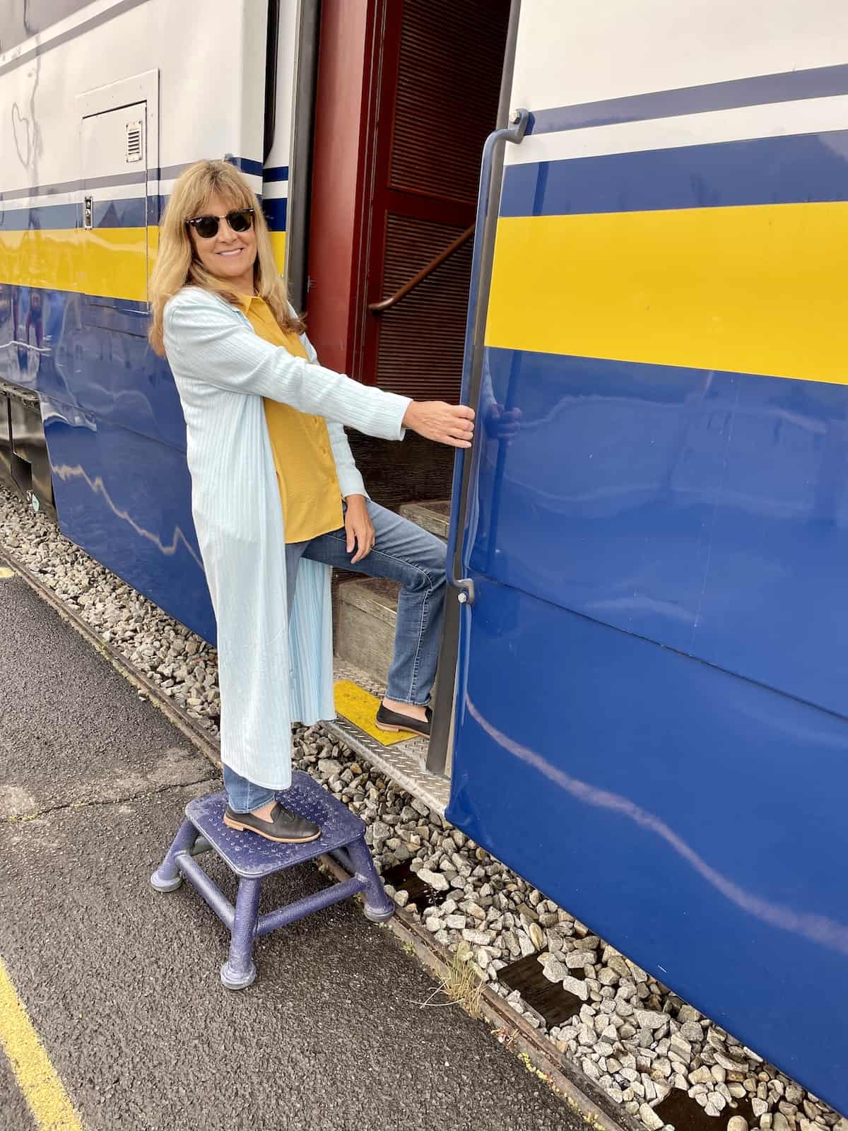 Woman getting on a train for Holland America Alaska excursions review.