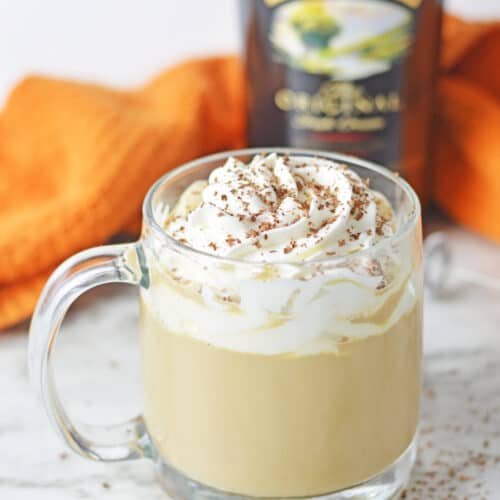 Baileys Latte in a glass mug with whipped cream.