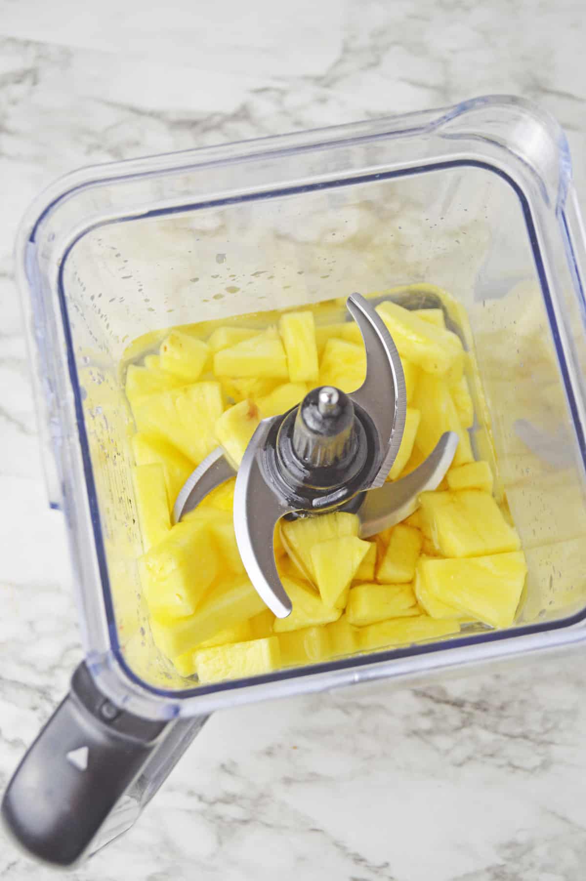 Making pineapple water in a blnder.