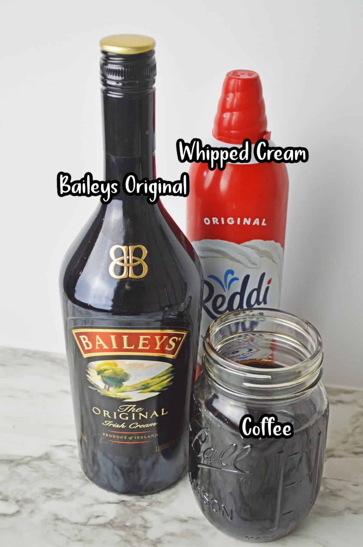 Ingredients to make Baileys Iced Coffee; Baileys, coffee, whipped cream.