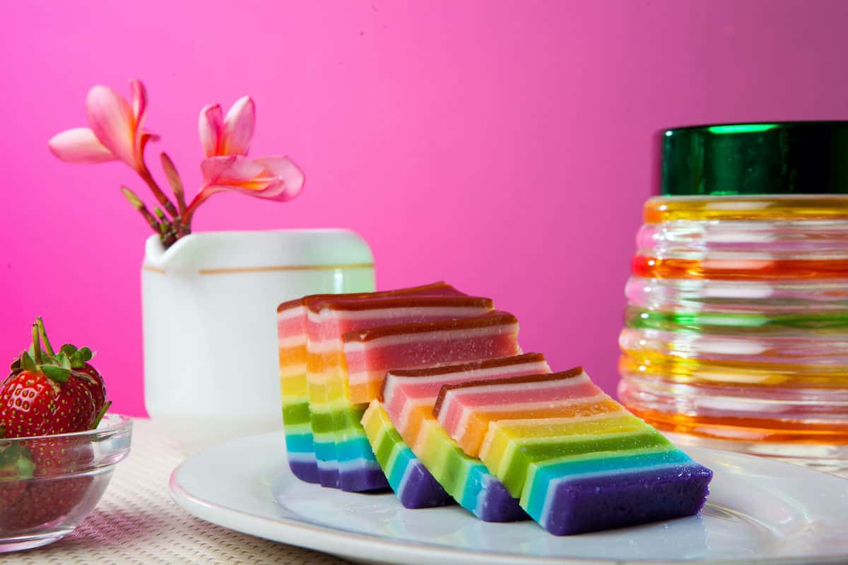 Rainbow Lapis Cake sliced on a white plate.