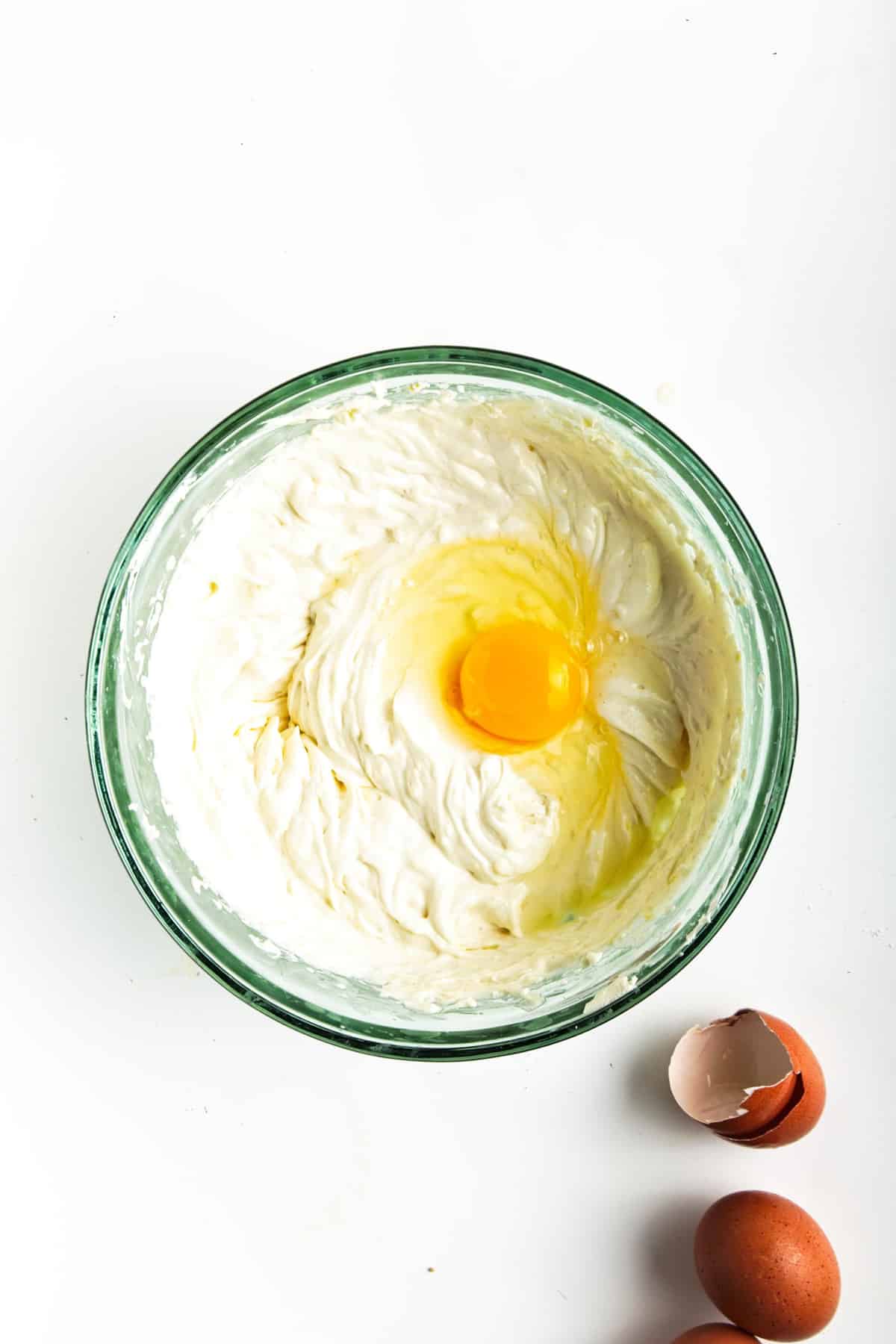 Cream cheese mixture in glass bowl with egg.