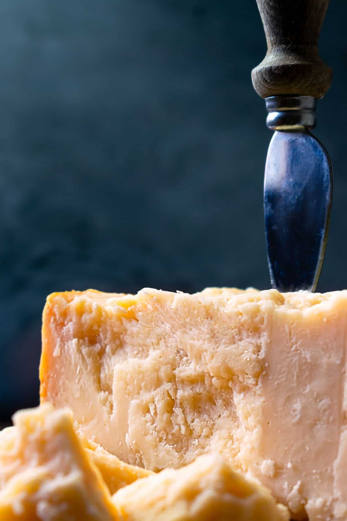 Parmesan cheese with knife.