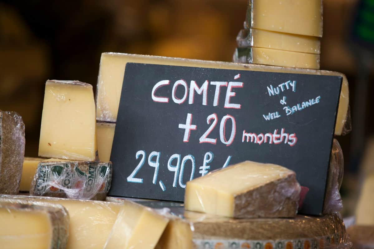 Comte cheese on display with sign.