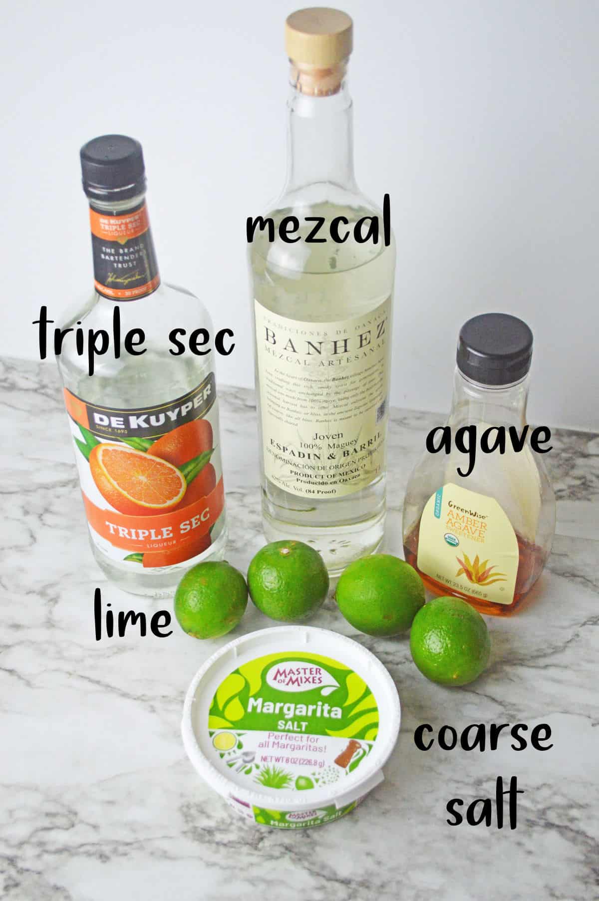 Ingredients for Frozen mezcal margarita on a white counter.