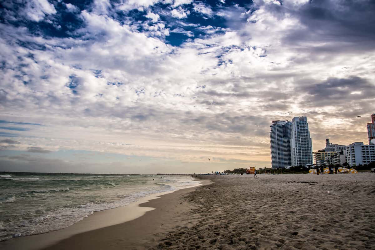 Beach with high rise buildings in background.