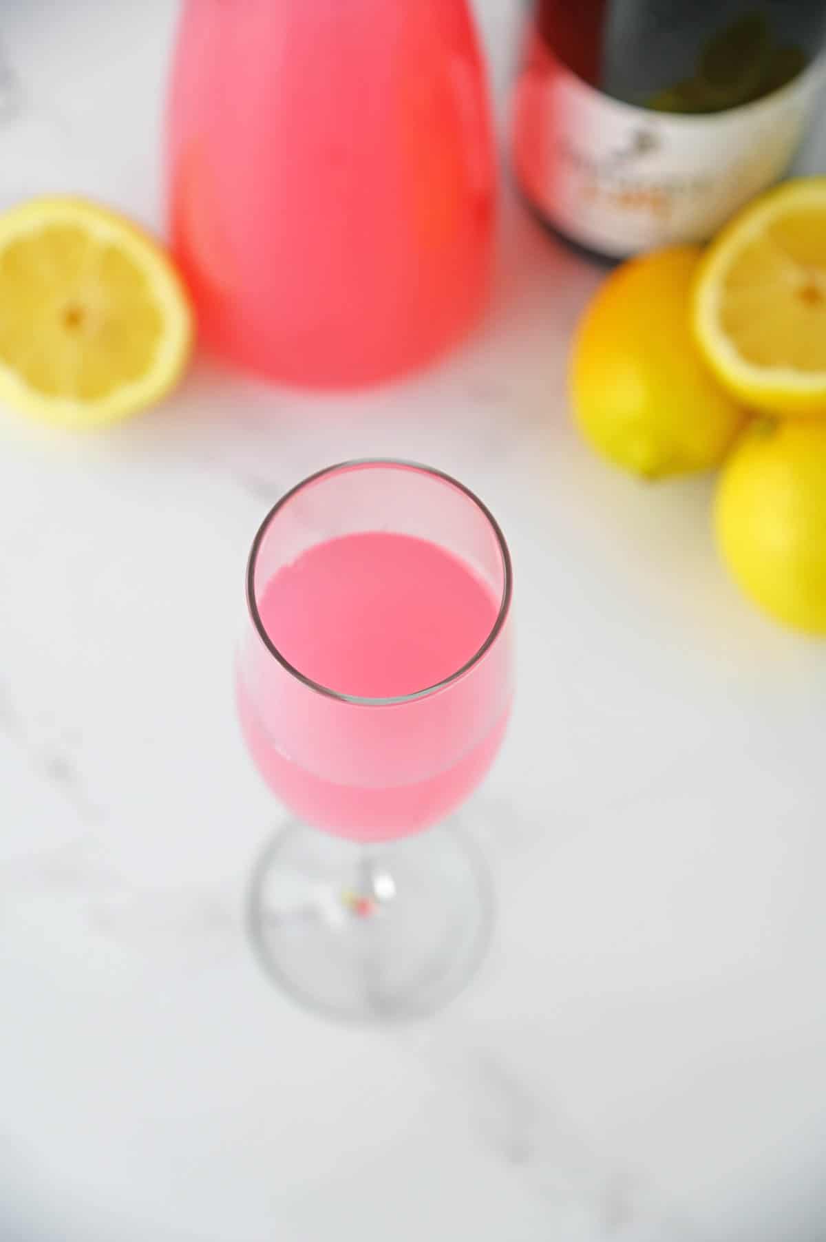 Pink lemonade in a champagne flute.