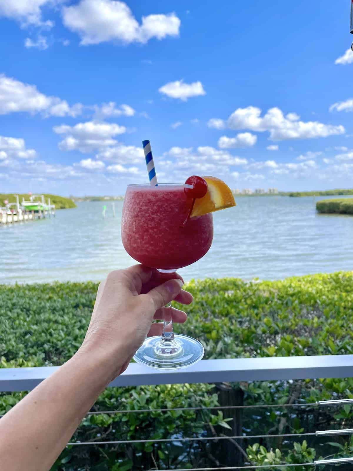 Frozen strawberry drink with view of bay in the background.