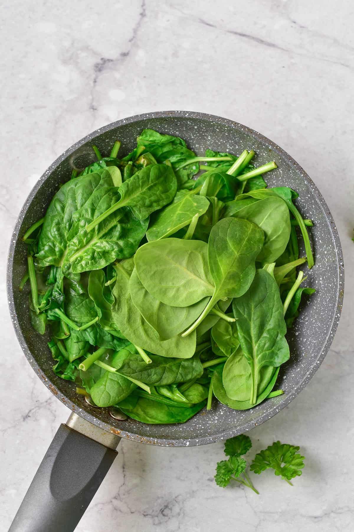 Spinach in saute pan.