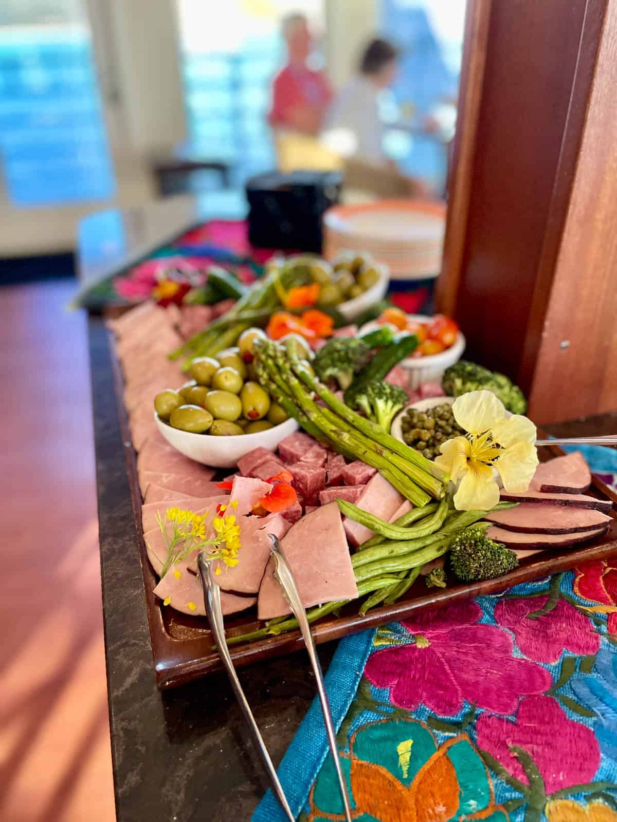 Vegetable platter with meat and olives.