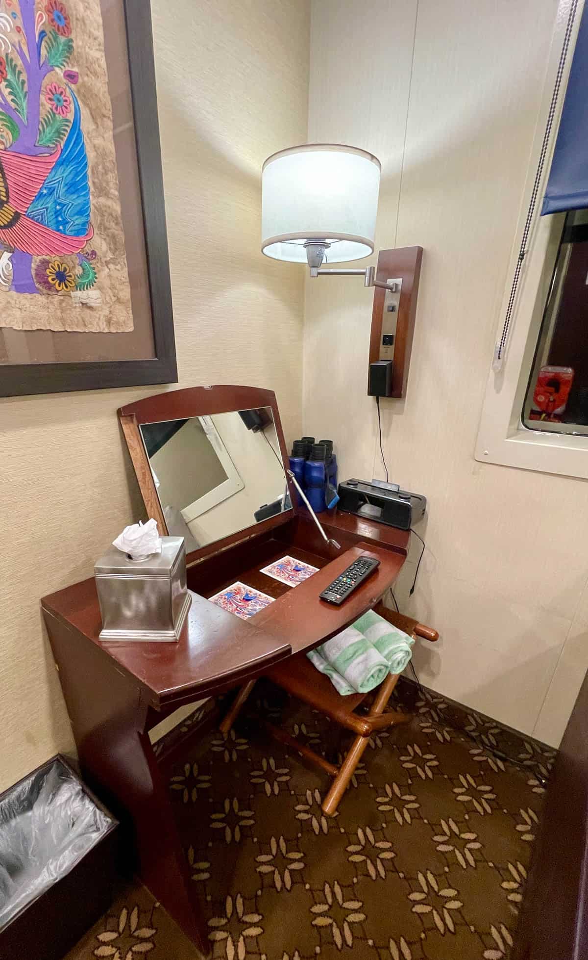 Vanity on brown carpet with tissue box and radio.