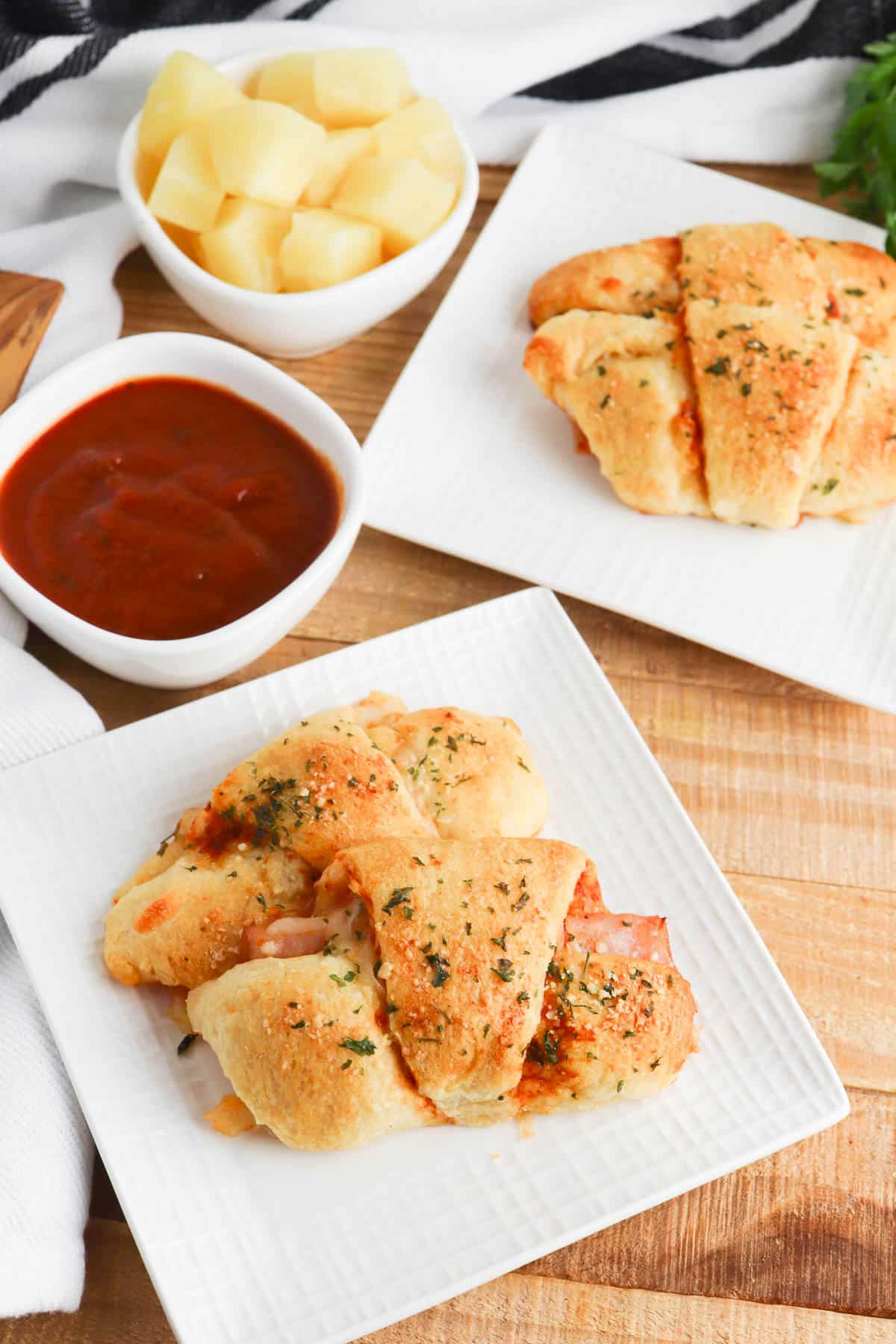 Ham and cheese crescent rolls with pineapple and pizza sauce.