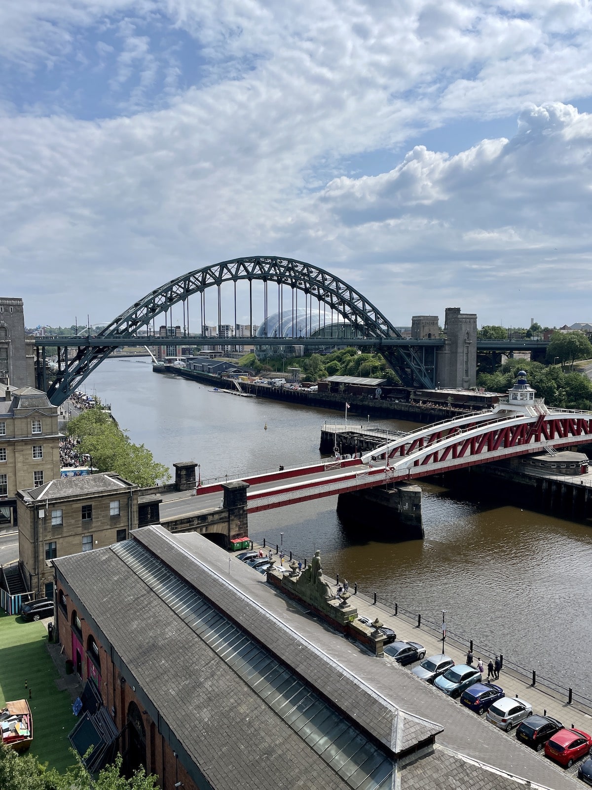 Bridge over river with buildings on either side.