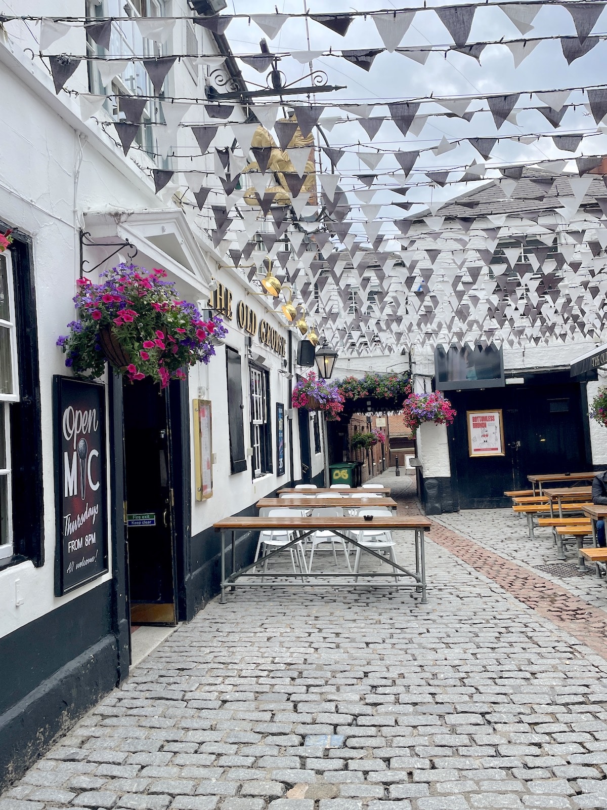 Restaurant with flags hanging across patio.