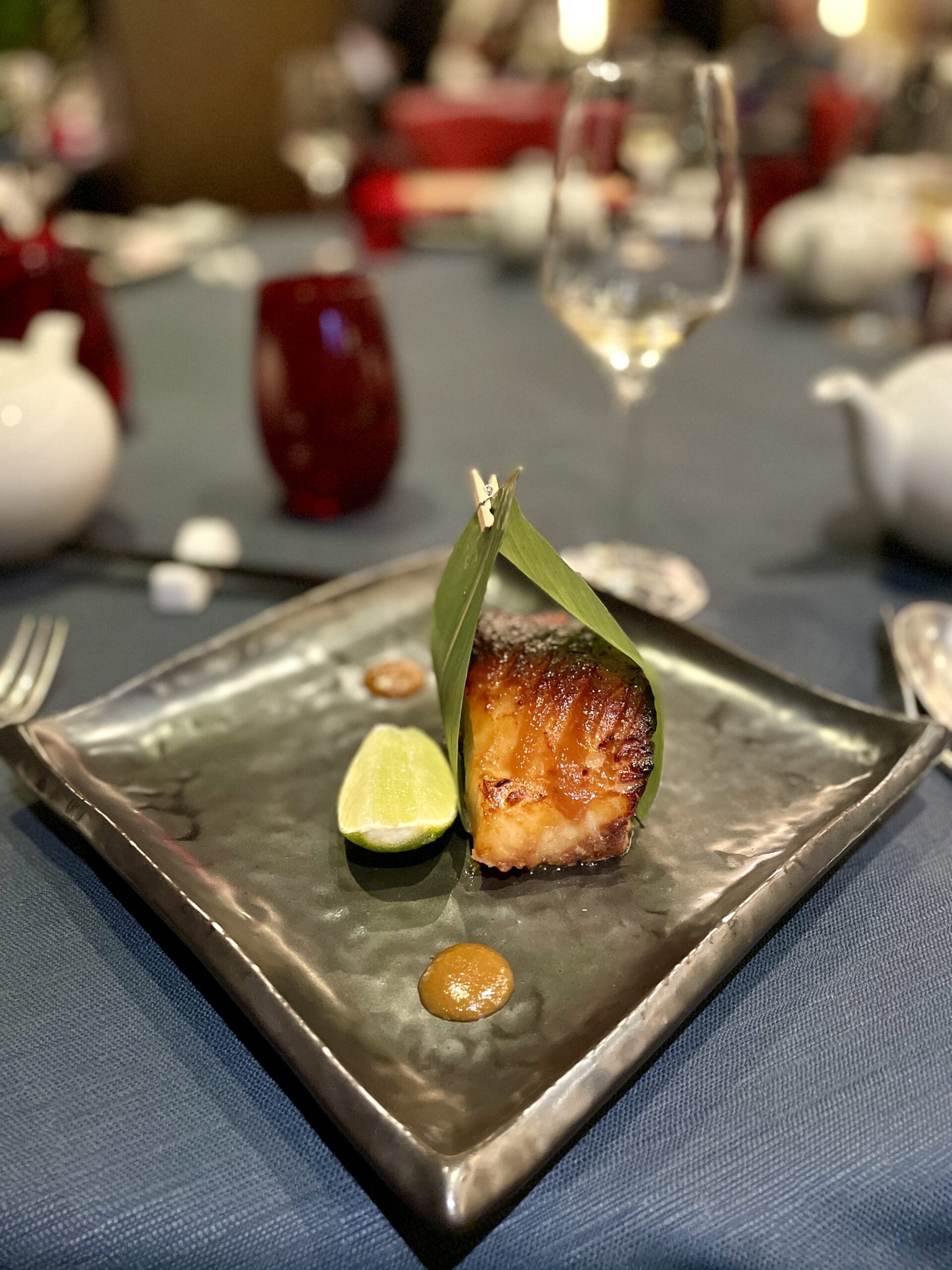 Fish seared and set in leaf with lime.