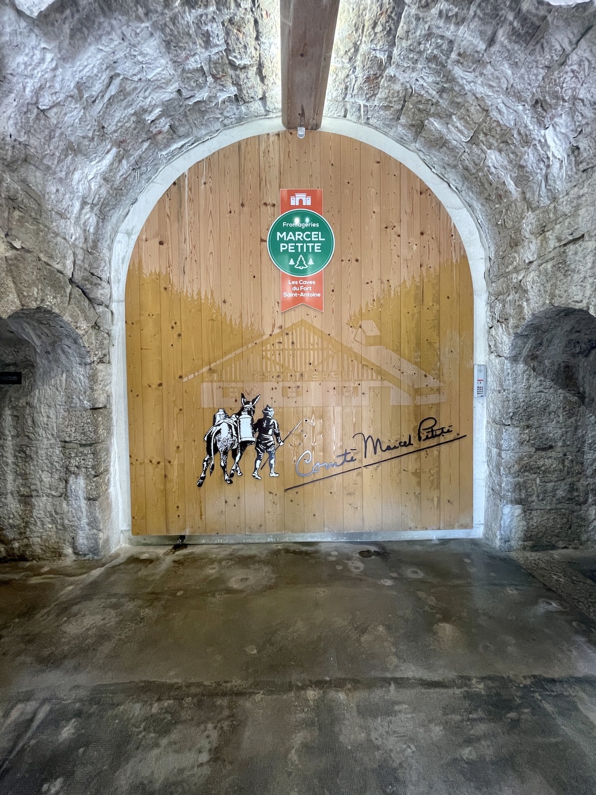 Fort Saint Antoine Comte France wood door with donkey carrying milk and shepherd.