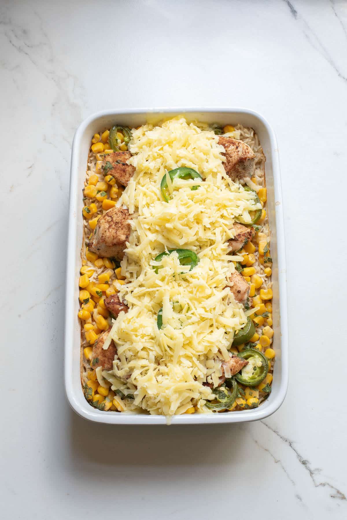 Chicken casserole topped with shredded cheese.