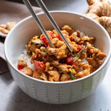 Chicken stir fry in a white bowl.