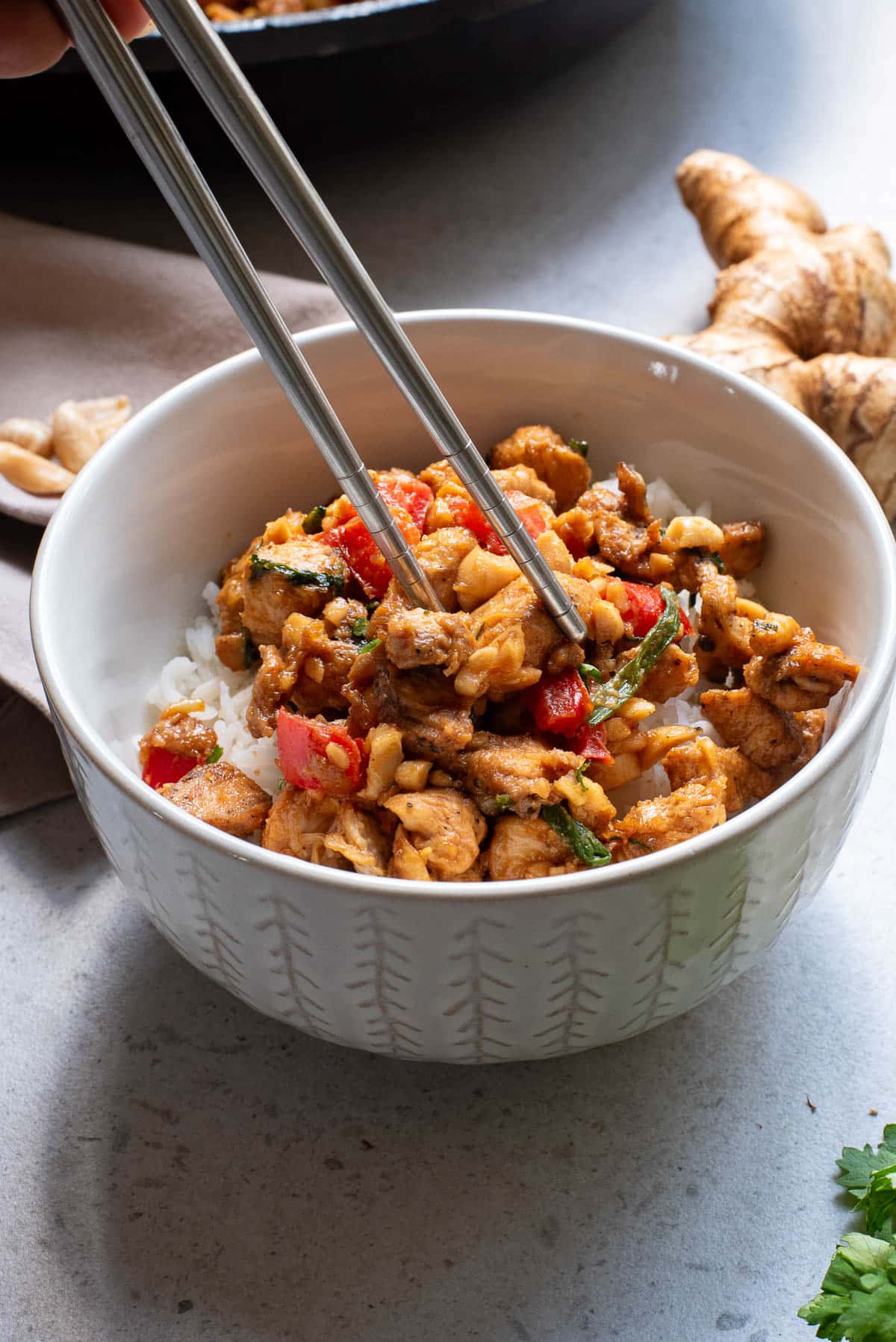 Chicken stir fry in a white bowl.