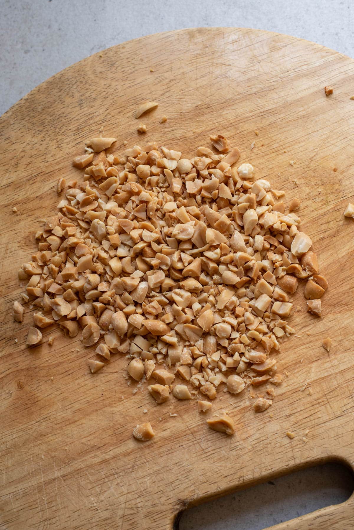 Chopped peanuts on a cutting board.